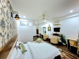 a hotel room with a bed and a desk at Arch Place in Gurgaon
