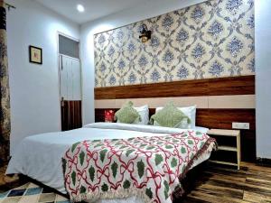 a bedroom with a bed with a red and white blanket at Arch Place in Gurgaon