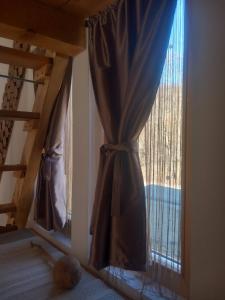 a window with a curtain in a room at Marin konak in Gornji Milanovac