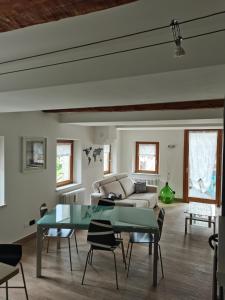 a living room with a couch and a table at Nancy House in Longarone