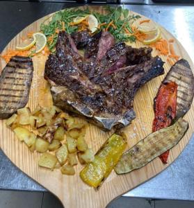 a plate of food with meat and vegetables on a table at Locanda dei Sapori in Marozzo