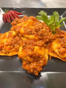 a pile of food on a black plate at Locanda dei Sapori in Marozzo +21 photos