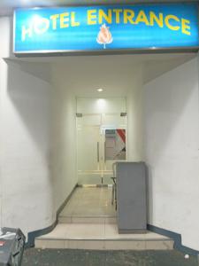 a hotel entrance with a sign on the wall at Nice Hotel Recto in Manila