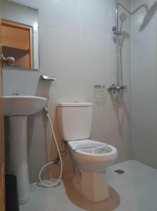 a bathroom with a toilet and a sink at Nice Hotel Recto in Manila