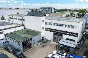an overhead view of a building with cars parked in a parking lot at D10 I shared bathrooms&kitchen in Garching bei München