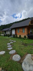 a yard with stepping stones in front of a house at บ้านพัก กามู Gamoo homestay in Chom Thong