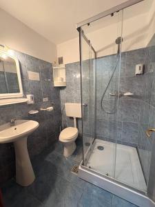 a bathroom with a shower and a toilet and a sink at Vila Aqua in Eforie Sud +36 photos