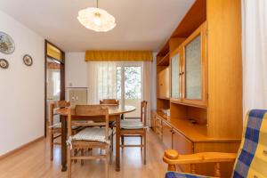 a kitchen and dining room with a table and chairs at Casa Anna in Predazzo