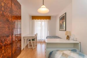 a bedroom with a desk and a bed and a table at Casa Anna in Predazzo