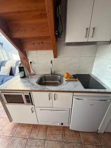 a kitchen with a sink and a counter top at Maison de la mer in Hendaye