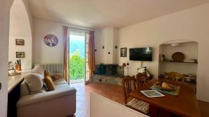 a living room with a couch and a table at La Ruota del Mulino in Nesso