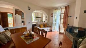 a kitchen and living room with a table and a couch at La Ruota del Mulino in Nesso