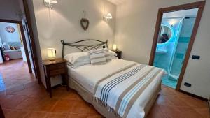a bedroom with a bed and a table with two lamps at La Ruota del Mulino in Nesso