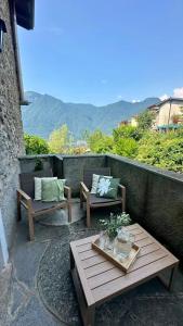 a patio with two couches and a table at La Ruota del Mulino in Nesso