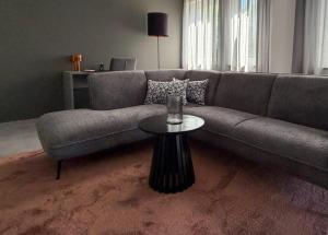 a living room with a couch and a table at TheKarlchen in Rheda-Wiedenbrück