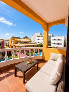 a living room with a couch and a table on a balcony at Casa Concha - Peaceful and Relaxing in Lagos