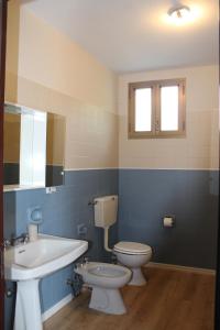 a bathroom with a sink and a toilet and a mirror at La Cà di Carol in Tollegno +33 photos