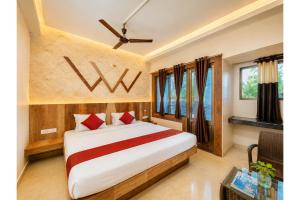 a bedroom with a large bed with red pillows at Hotel Sairaj inn - Restaurant - Free Wi-Fi - Premium Rooms - Balcony - Parking in Puri