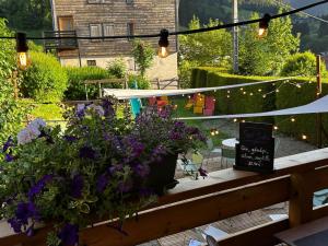 a garden with flowers and lights on a patio at Hôtel le Christiania in Arêches-Beaufort