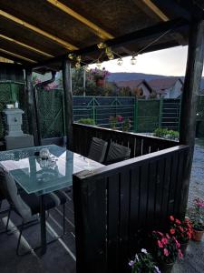 a patio with a table and chairs on a deck at Apartman Dimitrijevic in Bajina Bašta