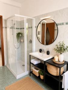 a bathroom with a shower and a sink and a mirror at Little house Lezzeno in Lezzeno +78 photos