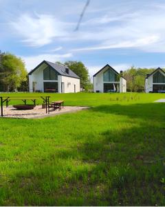 a park with a picnic table and a house at Ostoja Lubiatowo in Lubiatowo +27 photos