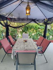 a table and chairs under a gazebo at Jenny's House in Yerakiní