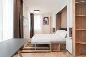a hotel room with a bed and a table at City Pop 2Night Geneva - Self check-in in Geneva
