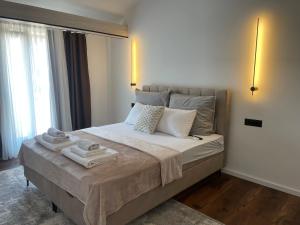 a bedroom with a large bed with towels on it at Villa Anri in Mostar