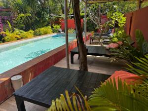 a swimming pool with a table and a bench next to it at SeaEsta Beach in Ban Tai