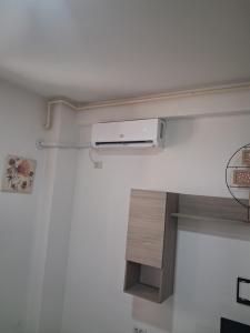 a room with a air conditioner on a wall at Modern 1-Bedroom Apartment with AC, Free Parking & Self Check-in Bucharest-Militari in Dudu +2 photos