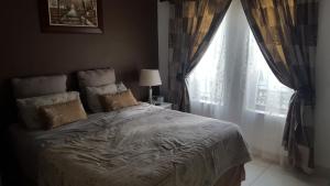 a bedroom with a large bed with a window at Unit 30 The Bridge - FAMILY UNIT IN A PRIME SPOT ON THE GROUND FLOOR in St Lucia