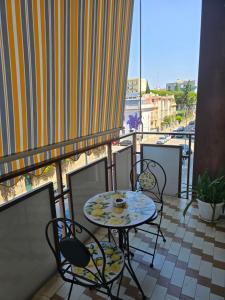 a balcony with a table and chairs on a balcony at Gli Amici della Puglia 2 in Taranto