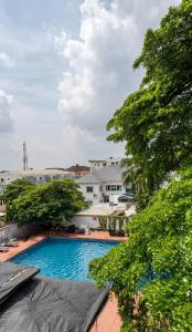 a view of a swimming pool with trees at Novatel Radisson Lekki in Lekki