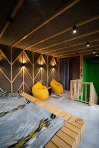 a room with two yellow bean bags on the floor at Liso Prostir in Lisopotik +50 photos