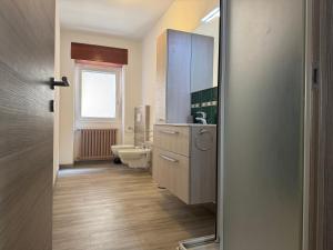a bathroom with a toilet and a sink at La Terrazza di Gino in Grosio +22 photos