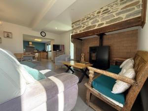 a living room with a couch and a fireplace at Larrouy in Asson