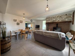 a living room with a couch and a fireplace at Larrouy in Asson