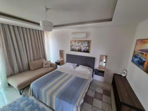 a hotel room with a bed and a couch at WEDAT APART On the beach Moda Marine Residence in Alanya +60 photos