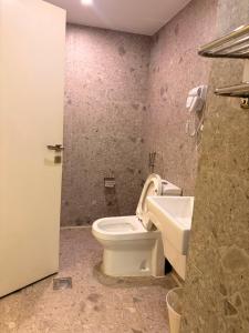 a bathroom with a toilet and a sink at Golden New Tulip in Abha