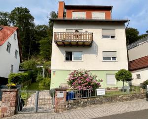 a person sitting on a balcony of a house at Ferienwohnung Wolff, Kelkheim in Kelkheim
