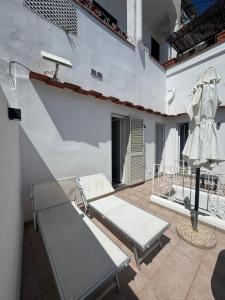 a patio with two chairs and a table on a building at Dietro la Piazzetta in Capri