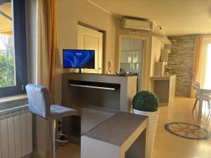 a living room with a tv and a chair at AirSisters Home in Ferno