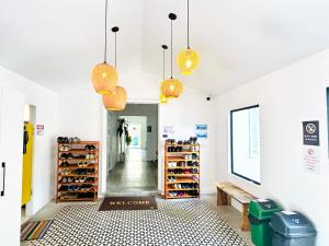 a store with yellow lights hanging from the ceilings at THE PLACE Hostel Phnom Penh in Phnom Penh