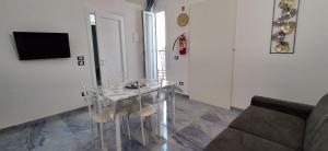 a glass table in a living room with a couch at ALG Apartments in Porto Cesareo