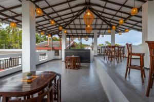 a restaurant with tables and chairs on a patio at Nova By Horizon Collection in Unawatuna