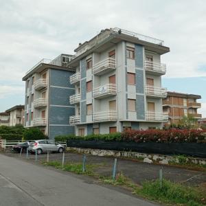 a building with cars parked in front of it at Sea Horse in Lido di Camaiore