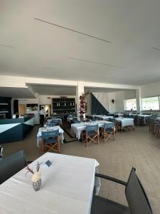 a dining room with tables and chairs and a room filled with tables and chairsktop at Marina Estensi Floating Resort - Classic Yacht in Lido degli Estensi
