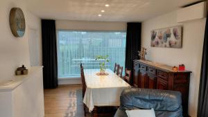 a dining room with a table and a window at B-SIDE Loppem in Zedelgem