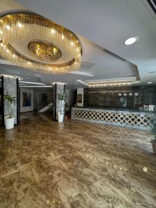 a ballroom with a dance floor and a chandelier at Almero Termal Spa Otel in Termal